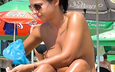 Pretty nudist teen enjoys her summer topless outdoors